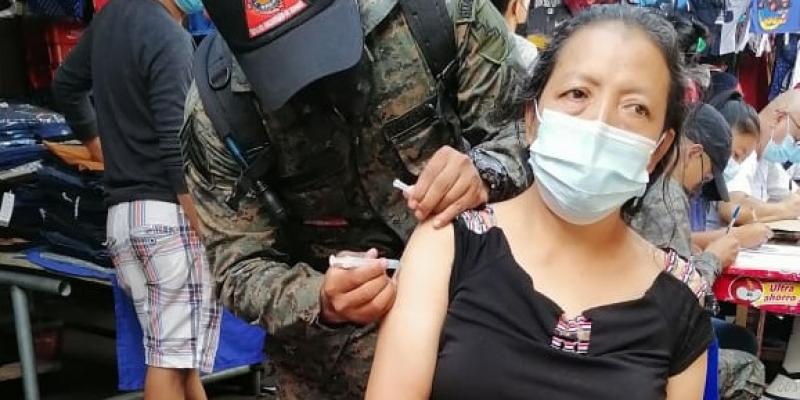 Los soldados en conjunto con el personal de salud, recorren los locales de este mercado para aplicar la vacuna a los locatarios.