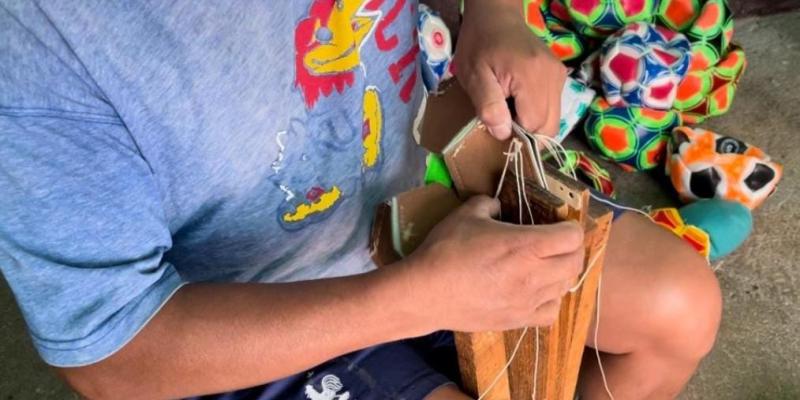 Reos aprenden a elaborar balones de futbol